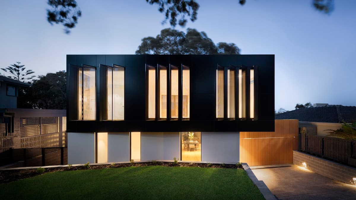 Stunning twilight photo of a luxury home with pool and landscaping