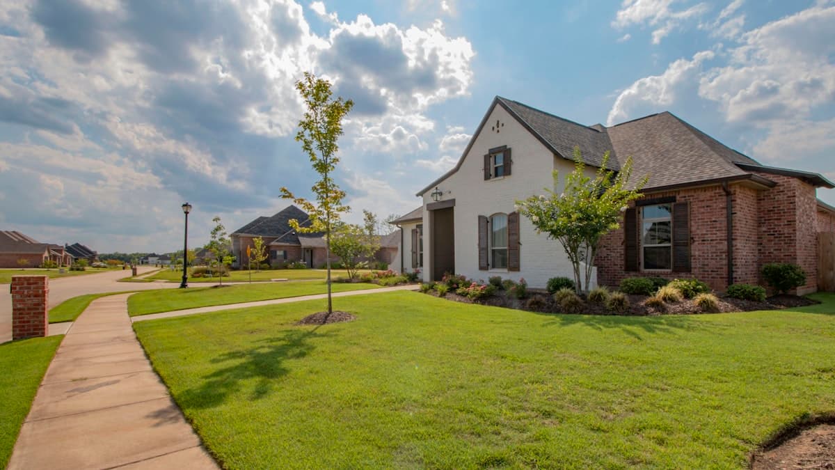 A real estate exterior photo showing a dramatic blue sky replacement over a modern home