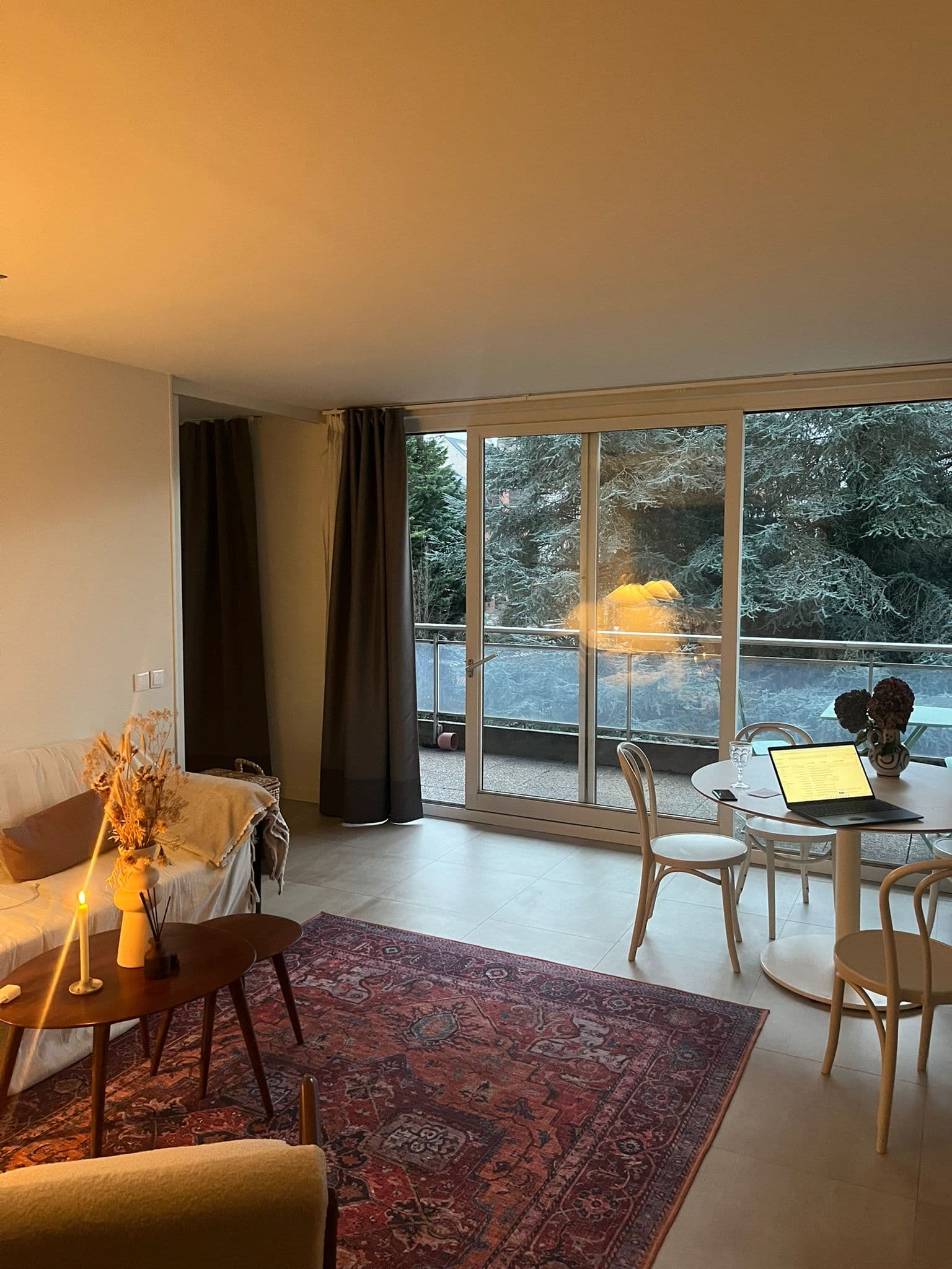 Dark Airbnb living room with underexposed interior and bright windows